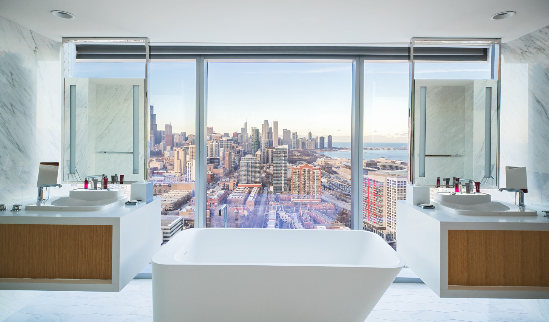 A part of Clark's hospitality portfolio, the presidential bathroom suite includes a freestanding tub with windows overlooking downtown Chicago