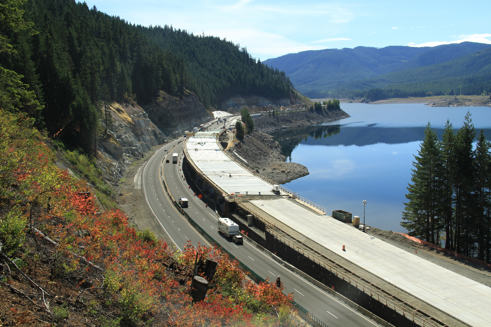 aerial view of I-90 Snowshed along the edge of a wooded hill next to water