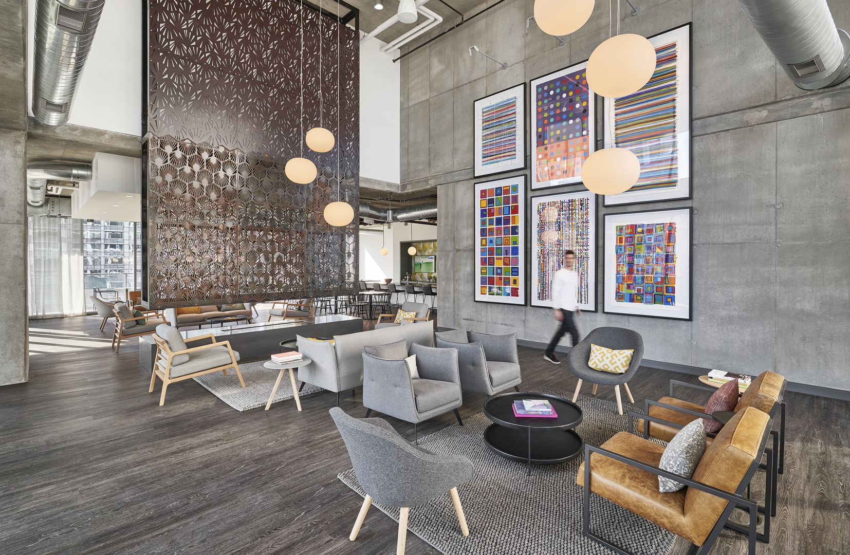 The interior of the residential building Parkline in Chicago with couches, chairs, and overhead lighting