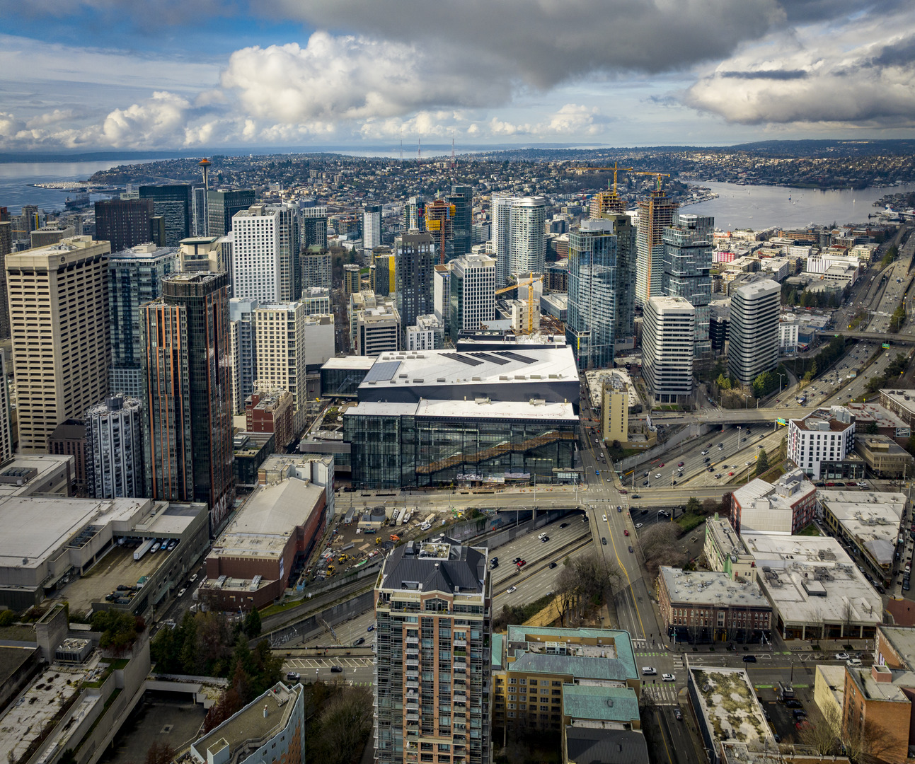Washington State Convention Center aerial view with the city around it and water behind it