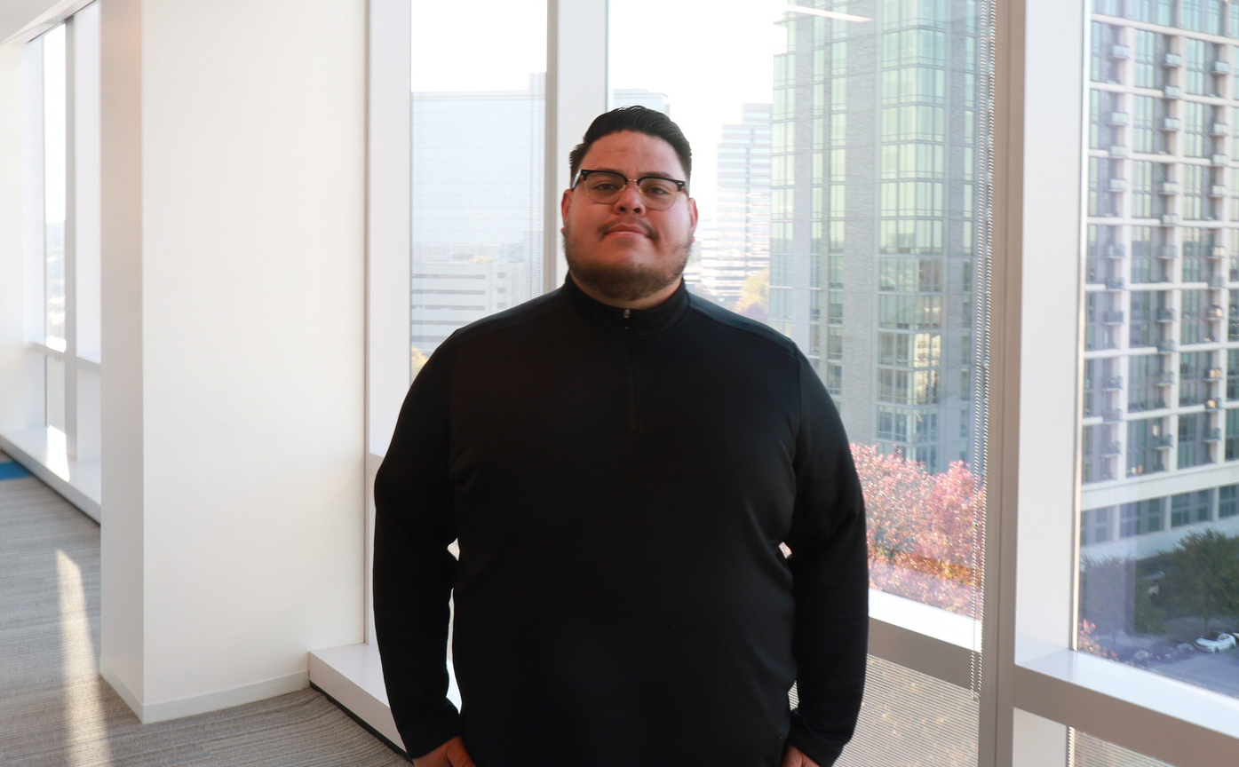 Tony Perez stands in front of a window in Clark Construction Group's office