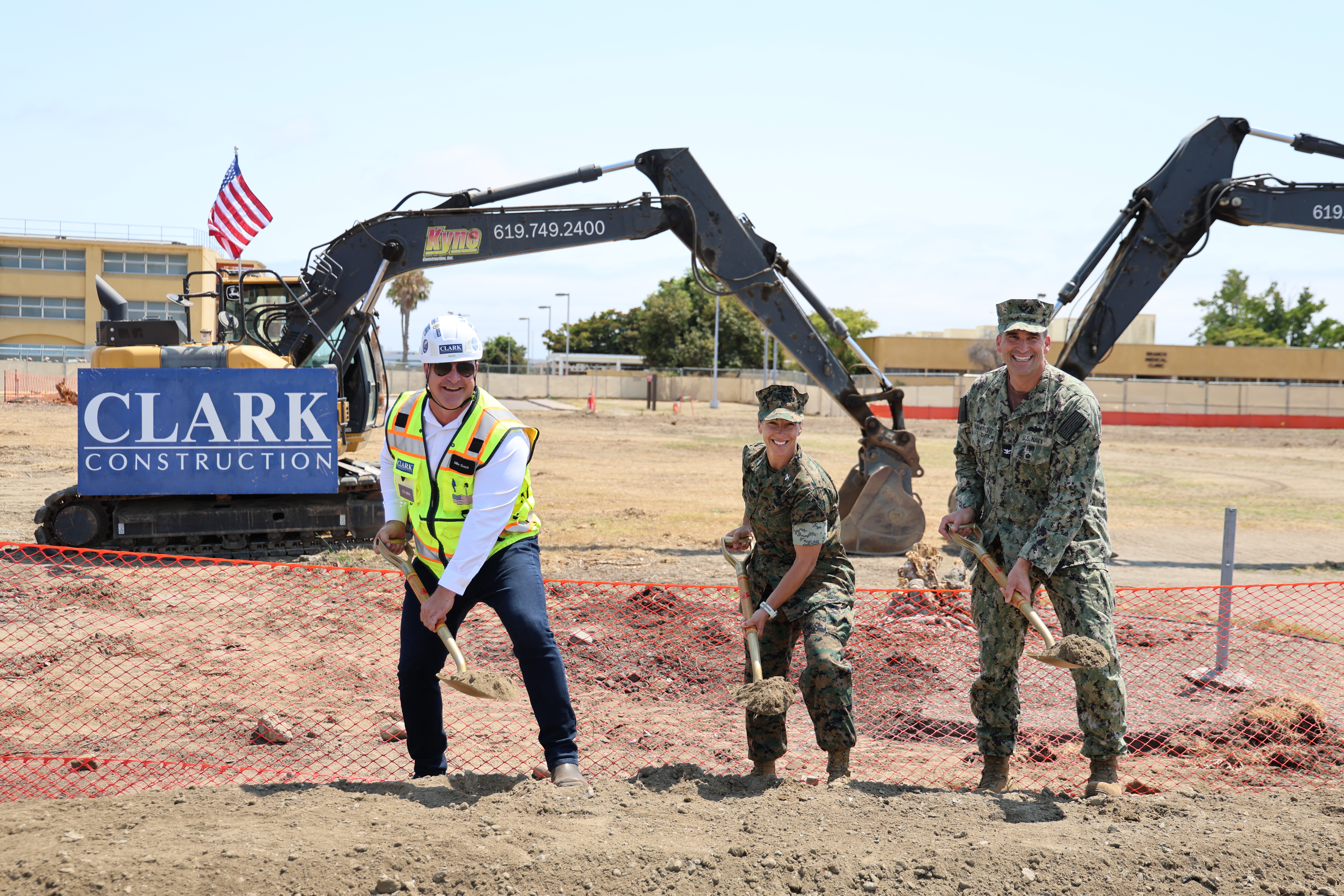 Clark Construction Vice President Mike Guzzi, Colonel Tracy Maese, and CAPT Ben Wainwright ceremonially break ground on the project.