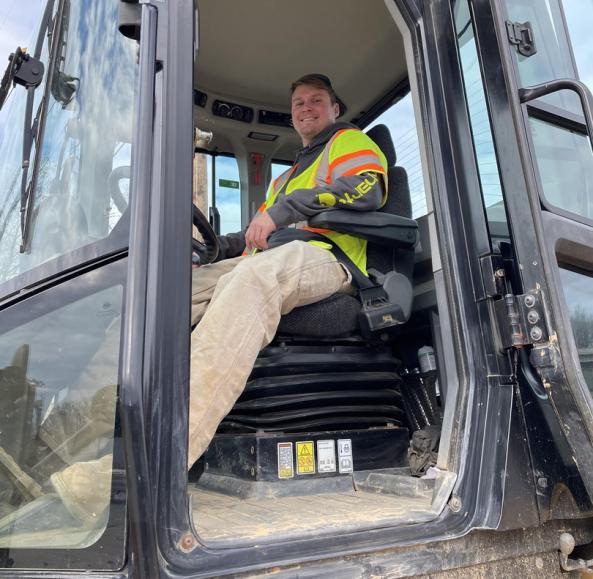 Operator operating engineer sits in the machine