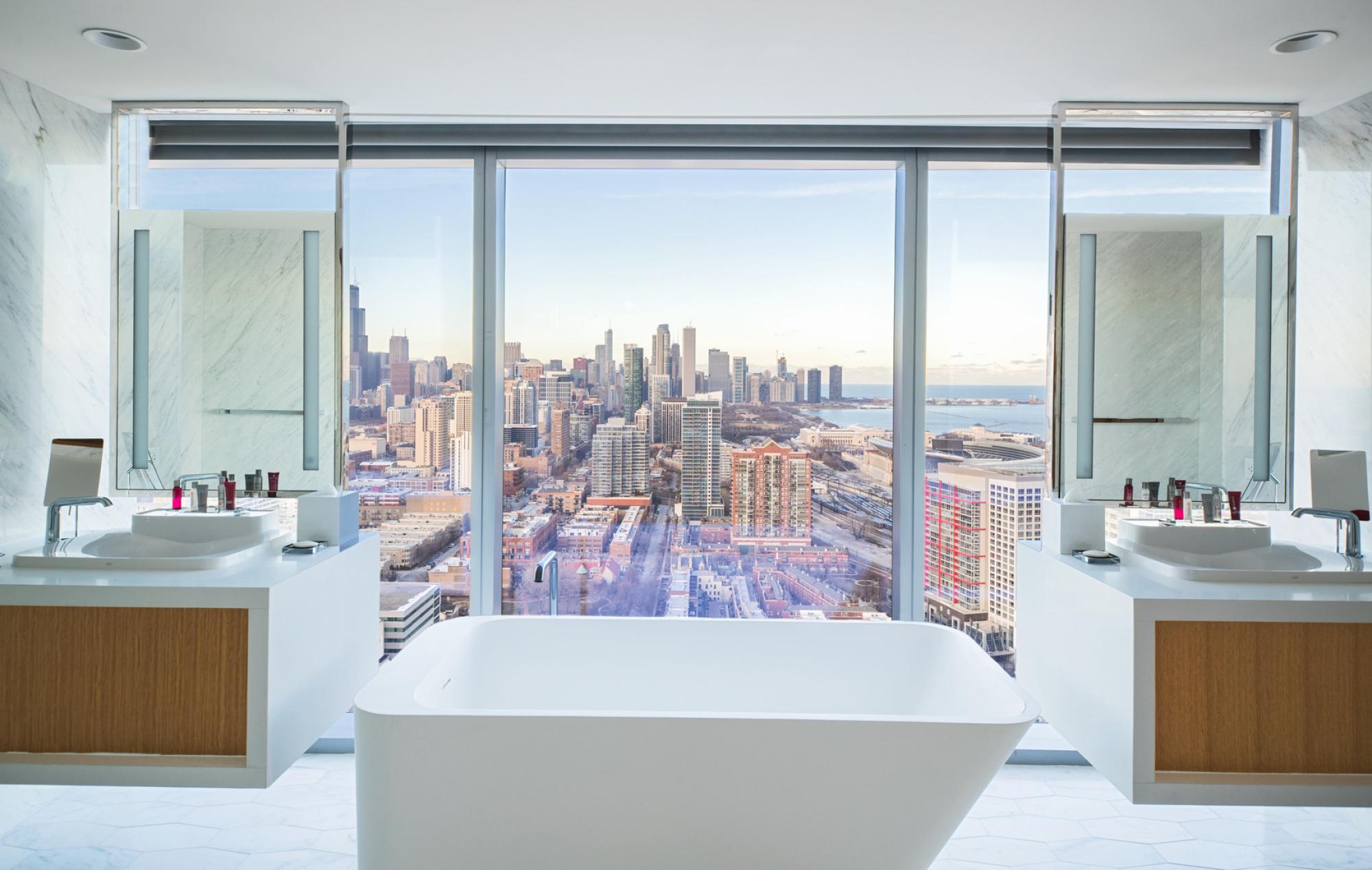 A part of Clark's hospitality portfolio, the presidential bathroom suite includes a freestanding tub with windows overlooking downtown Chicago